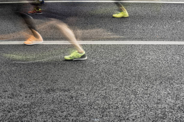 istock People running in marathon on city streets. Motion blur. 920931938