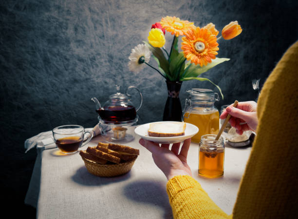 istock Woman having breakfast with toasts and honey 920931944