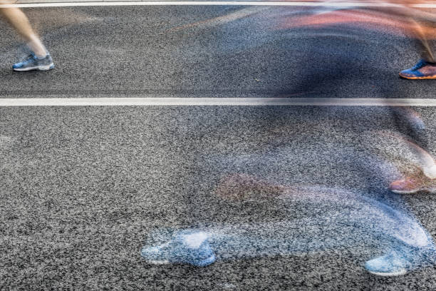 istock People running in marathon on city streets. Motion blur. 920931948