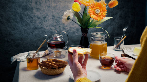 istock Woman having breakfast with toasts and honey 920931958