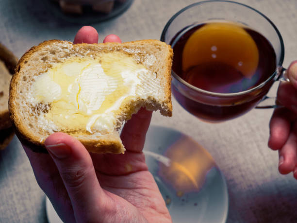 istock Woman having breakfast with toasts and honey 920931988