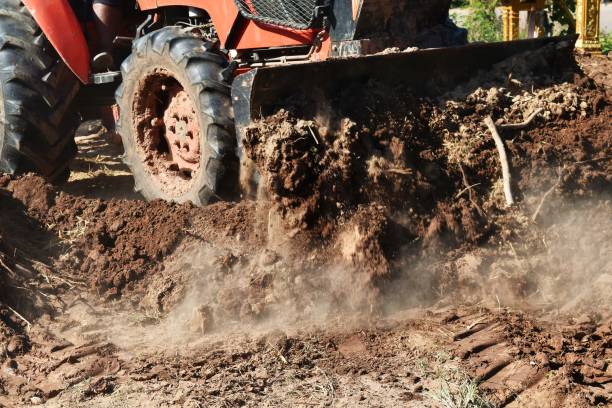 istock tractor push clot soil after pour from truck 920932342