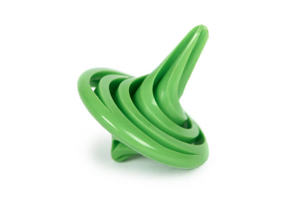 Green plastic toy gyroscope, kid spinner isolated on white background.