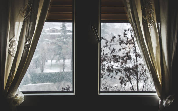 istock thermal insulation window save energy bills snow fall view winter dark window curtain stay home snowing outside 920932582