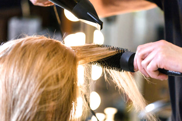 istock Hairdresser using hairdryer 920932724