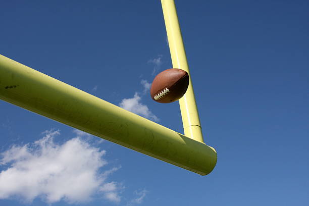A concept showing posts on a reflective concrete lined american football field backlit by a single honeycomb spotlight - 3D render