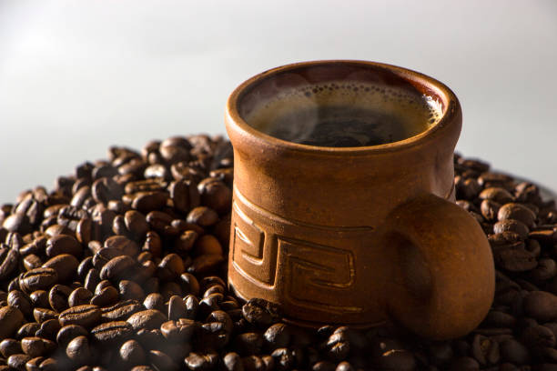 istock clay cup with coffee on the background of grains 920935084