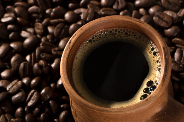 istock clay cup with coffee on the background of grains 920935136