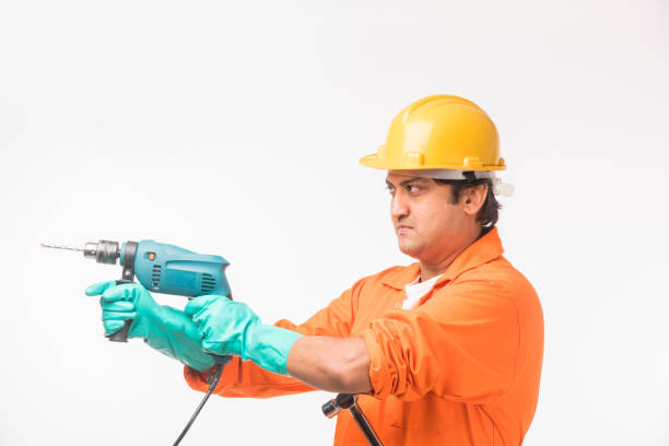 istock Indian electrician engineer in action with wire cutter, standing isolated over white background 920935548
