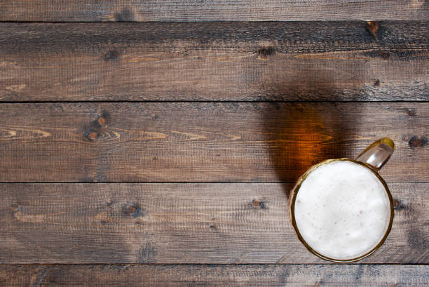istock Wooden background with beer mug 920938410