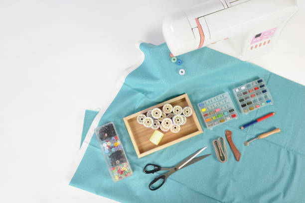 istock Sewing machine and colorful thread rolls, scissors, fabric and accessories for sewing on white background, Sewing and needlework concept. (Selective Focus) 920949052