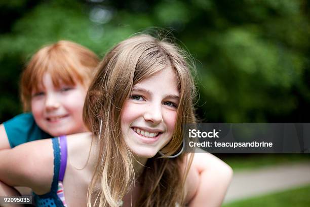 Piggyback Sisters Stock Photo - Download Image Now - Blond Hair, Redhead, Sibling