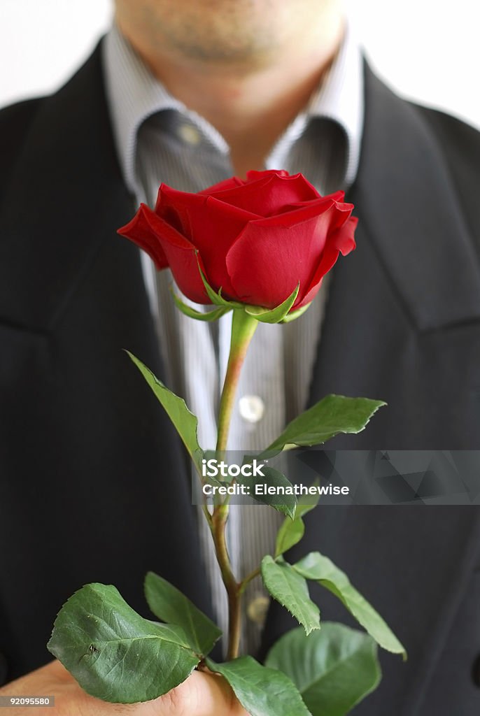 Man red rose Man in black suit holding a red rose Adult Stock Photo