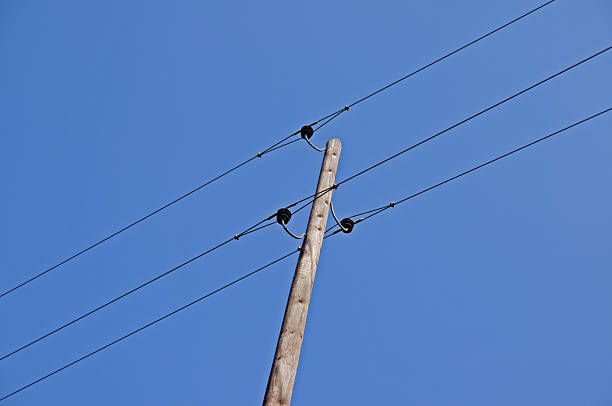 istock Wooden electricity pylon with power line and insulators 92096284