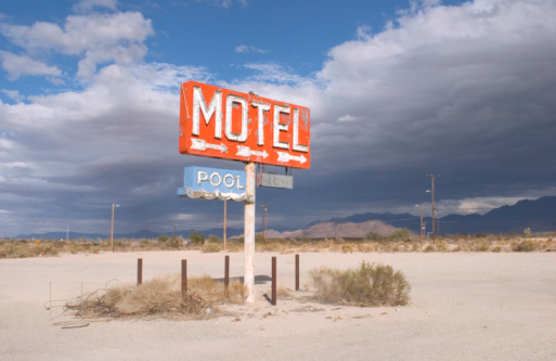 Amboy, CA / USA – April 1, 2017: View of the historical Roy’s Motel sign and small cabins located on Route 66 in Amboy, California.