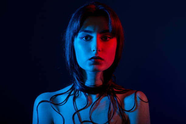 istock woman in multicolor lights 920969422