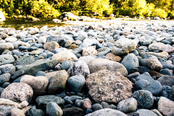 istock Stones, pebbles and sand on the shore of a mountain river 920972380