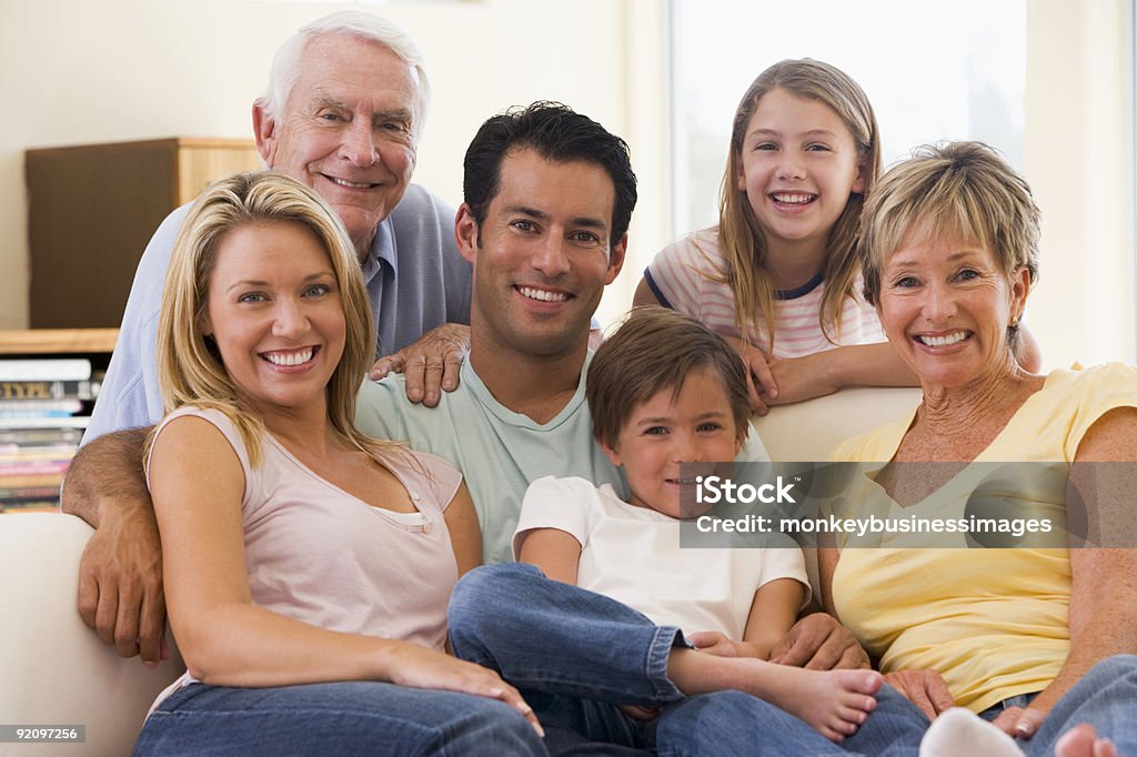 Extended family in living room smiling  30-39 Years Stock Photo