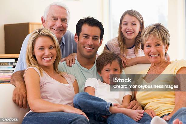 Extended Family In Living Room Smiling Stock Photo - Download Image Now - 30-39 Years, 60-69 Years, Active Seniors
