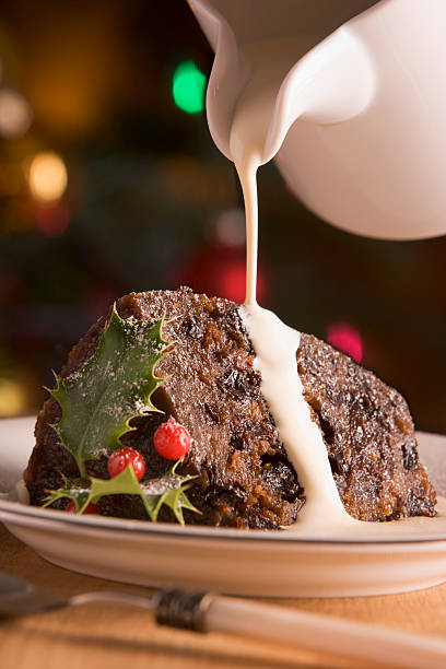 Portion of Christmas Pudding with Cream  christmas pudding stock pictures, royalty-free photos & images