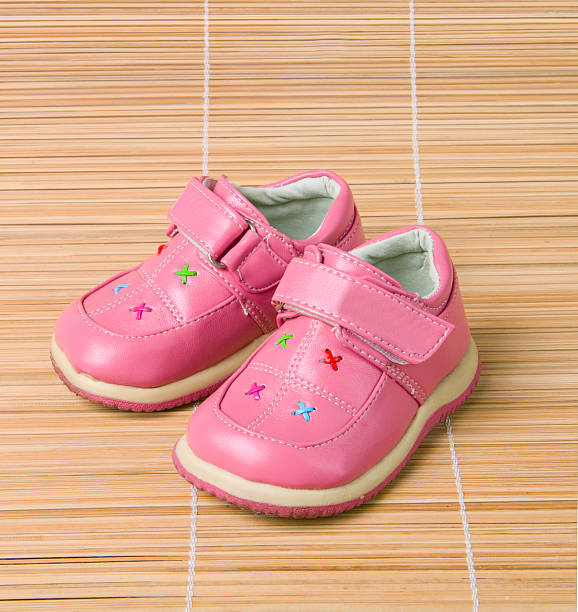 istock Pink children's shoes on bamboo 92097411