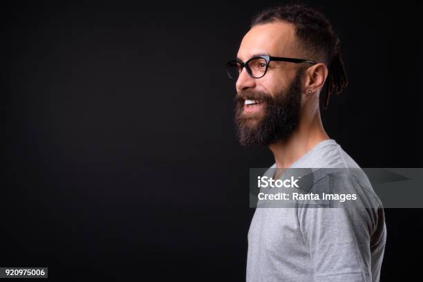 Handsome Young Man Against Black Background Stock Photo - Download Image Now - Profile View, Portrait, Black Background