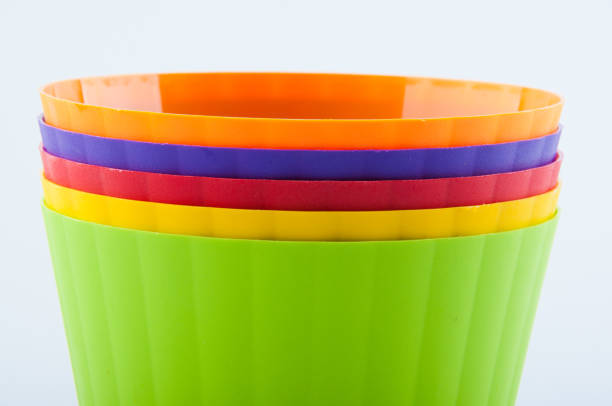 istock Pile of different color plastic flower pots on white background 920975080