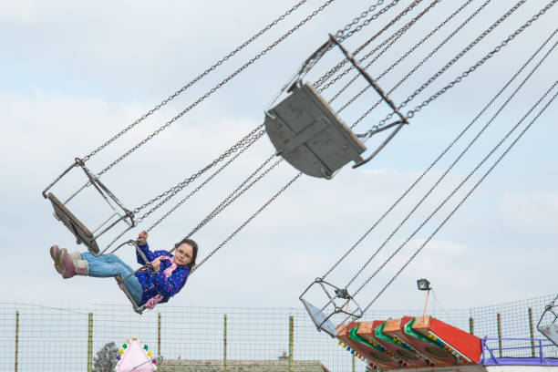 istock Girl flying on the carousel 920975340