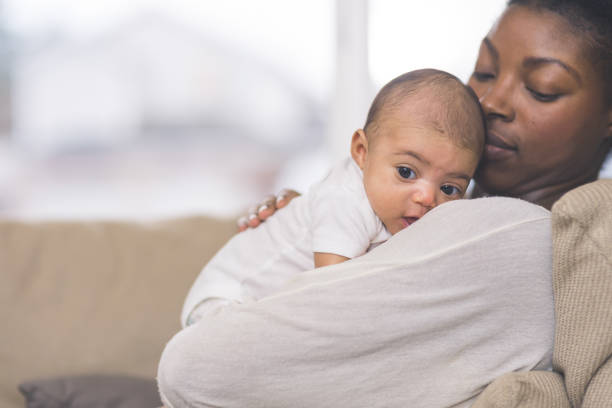 istock Mama holding her newborn baby 920978836