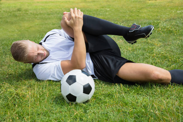 istock Male Soccer Player Suffering From Knee Injury 920982050