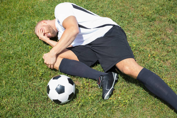 istock Male Soccer Player Suffering From Knee Injury 920982070
