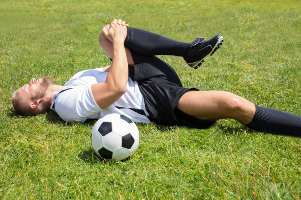 istock Male Soccer Player Suffering From Knee Injury 920982072