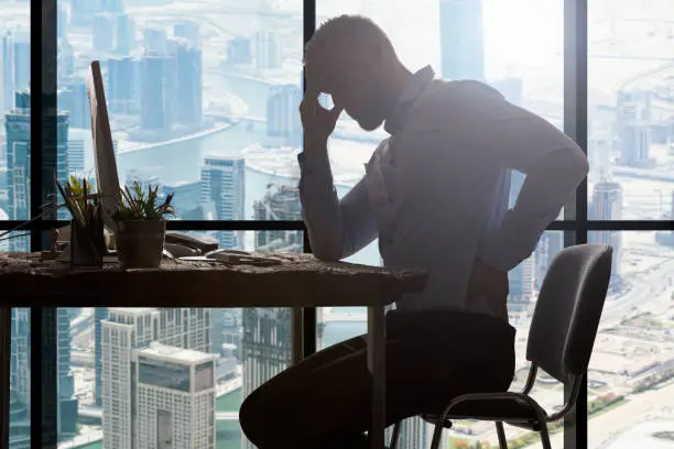 Young Businessman Suffering From Backpain In Modern Office