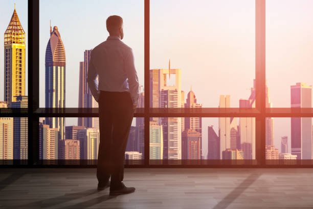 istock Businessman Looking At Cityscape Through Window 920982186