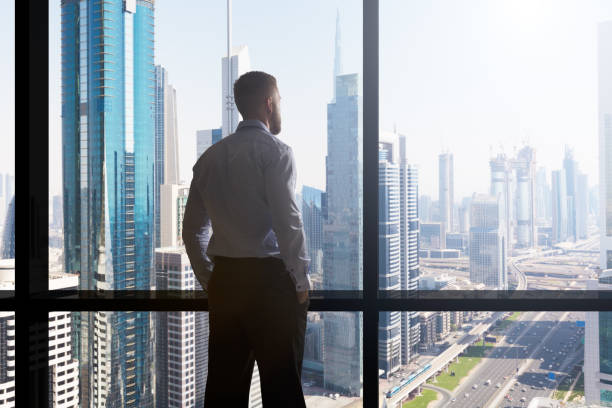istock Businessman Looking At Cityscape Through Window 920982190