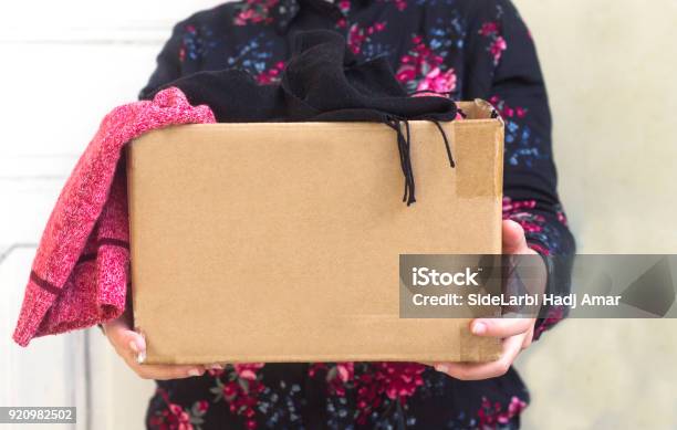 Woman Holding Cardboard Box With Clothing During Clothing Drive Stock Photo - Download Image Now