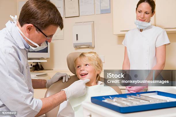 Young Boy Examined By A Dentist While Assistant Looks On Stock Photo - Download Image Now