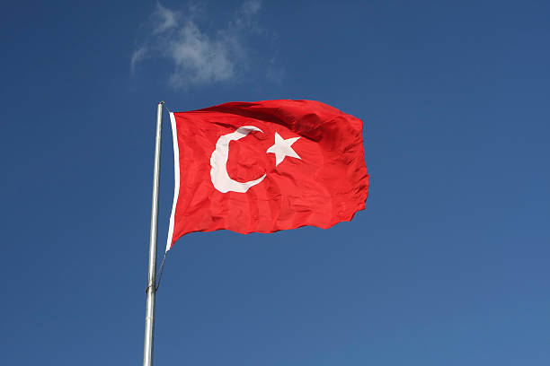 istock Against blue sky flies a Turkish red and white Flag 92098595