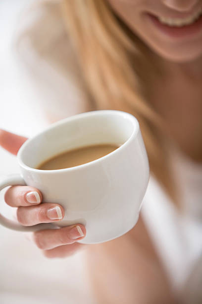 istock White coffee mug being held by a woman 92098689