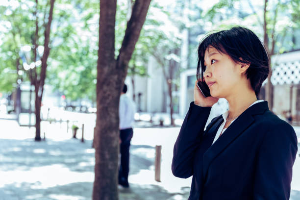 Young female receptionist receiving phone calls at office reception. Click here for other business images: 