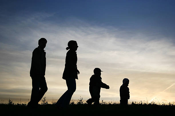 istock walking family of four on sky 92099170