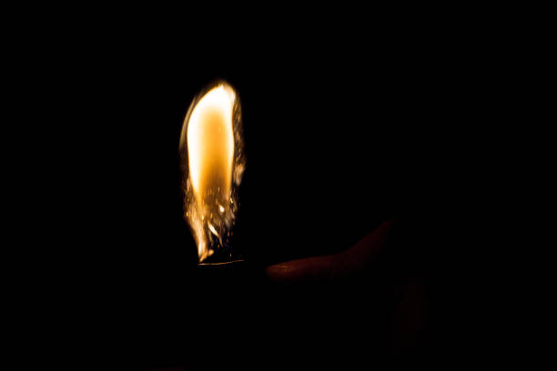 istock Close up view of real sparking light from lighter in dark black background 920993140
