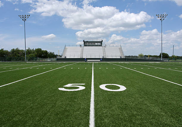 Outdoor American Football Stadium and Bleachers at 50 yard line stock photo