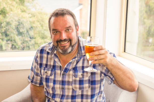 istock Middle aged man enjoying beer and pizza 920996006