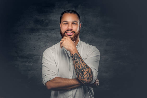 istock Black man with tattoo on arms. 920998148
