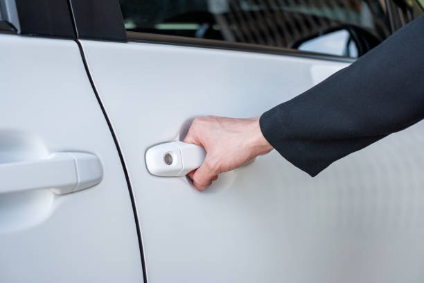istock Formal hand on handle opening a car door 920998418
