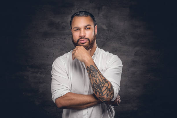 istock Bearded black man with tattooed arm. 920999158