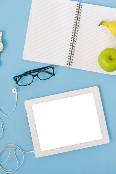 istock Tablet with blank screen on blue background, top view. Education background 921013298