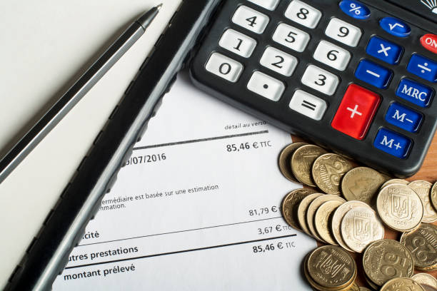 istock Finance and budget concept. Calculator, pen and coins on office table 921013554
