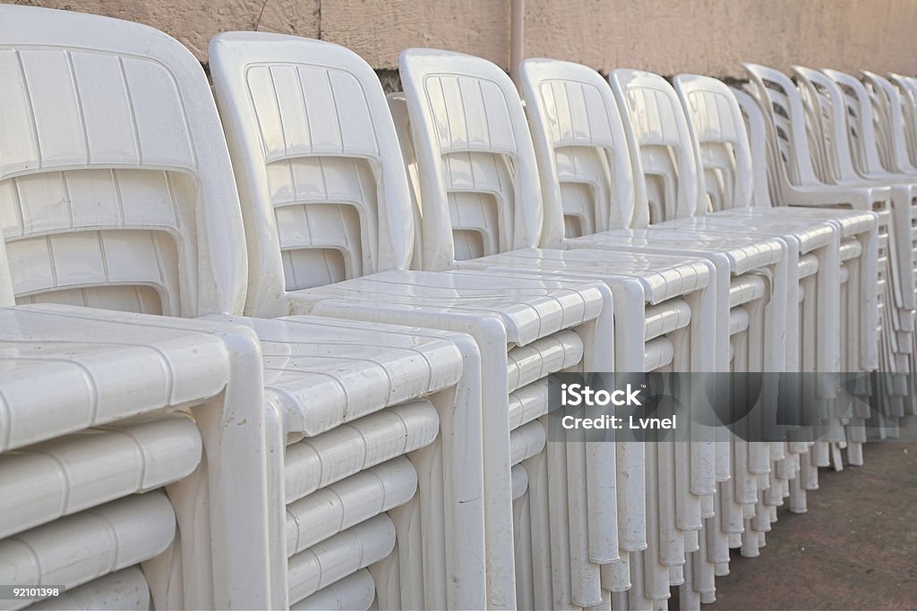 stacked white chairs  Breaking Stock Photo